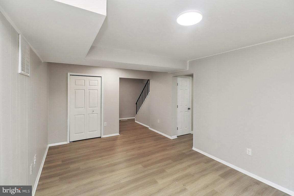 6551 Cornell Road Bryans Road, MD 20616 - Photo 3 of 25 an empty room with wooden floor & windows