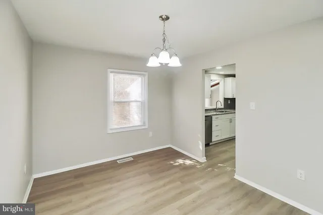 a view of a room window and wooden floor