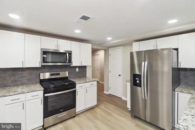 a kitchen with a refrigerator stove and microwave