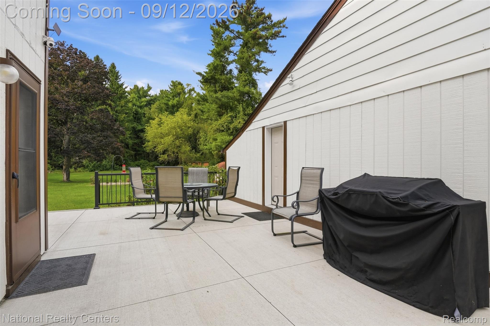 2631 Garden Road Milford, MI 48381 - Photo 28 of 40 Spacious concrete patio with black metal railing, offering direct outdoor access