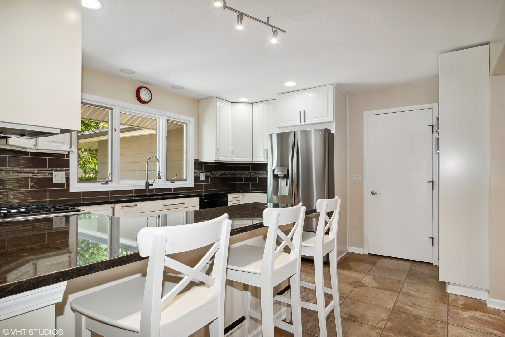 1875 Alschuler Drive Aurora, IL 60506 - Photo 5 of 16 a kitchen with stainless steel appliances kitchen island granite countertop a refrigerator and cabinets