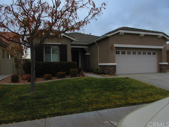 10486 Nobleton Road Apple Valley, CA 92308 - Photo 1 of 1 a front view of a house with a garden