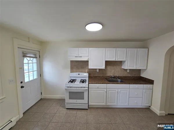 a kitchen with stainless steel appliances granite countertop a sink and cabinets
