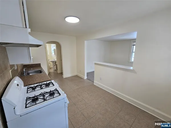 a kitchen with a stove and a refrigerator