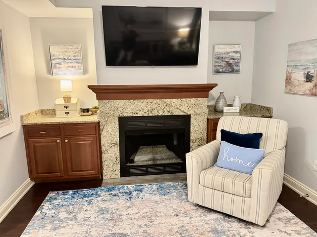 a living room with furniture and a fireplace
