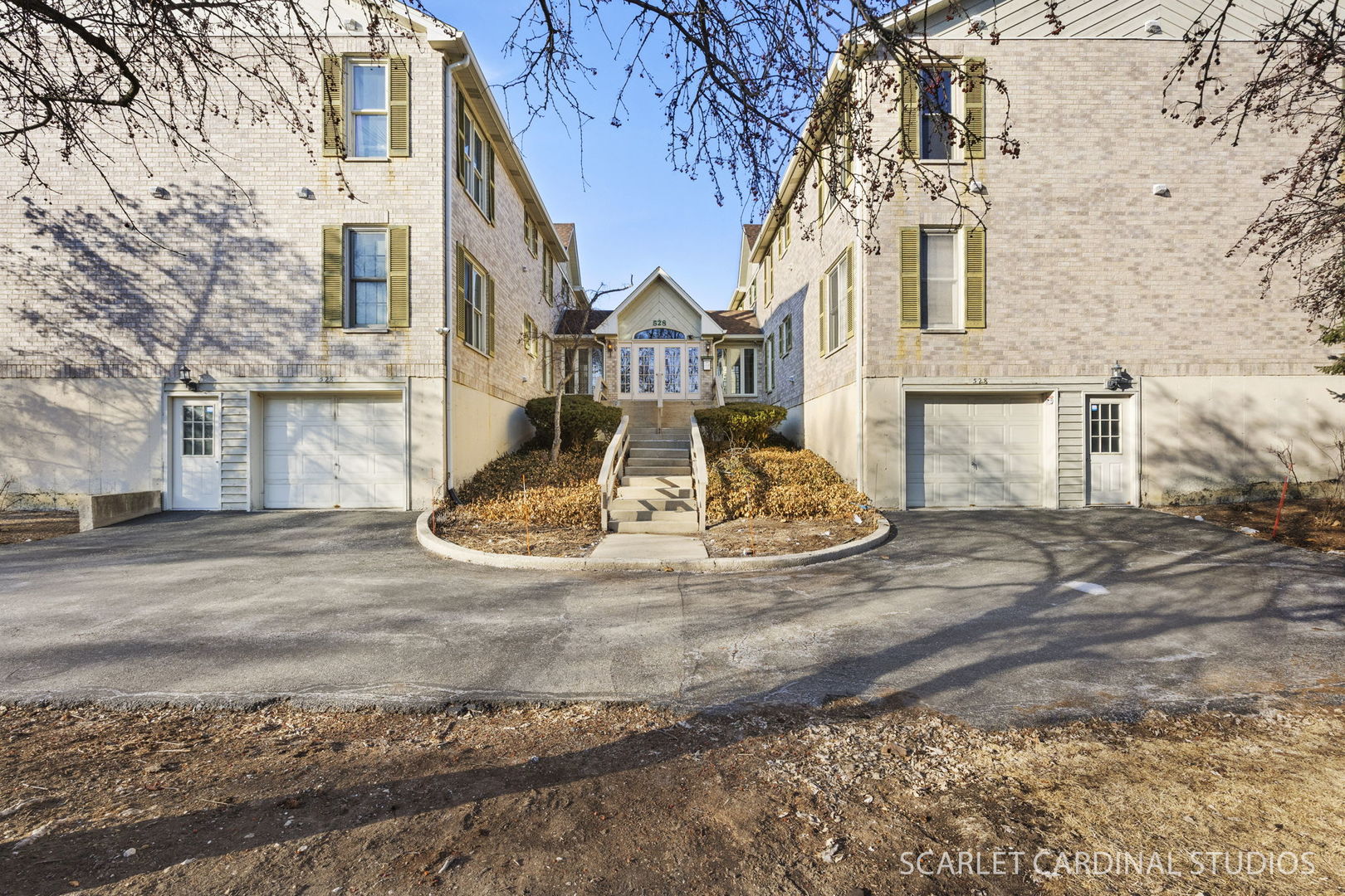 528 Pershing Avenue, Unit G Glen Ellyn, IL 60137 - Photo 1 of 14 a view of a white house with large windows next to a road