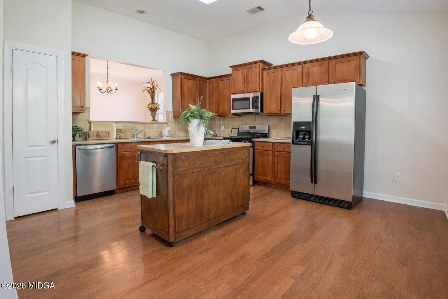 339 Fairways Drive Macon, GA 31220 - Photo 11 of 37 a kitchen with stainless steel appliances granite countertop a refrigerator a stove a sink and dishwasher with wooden floor