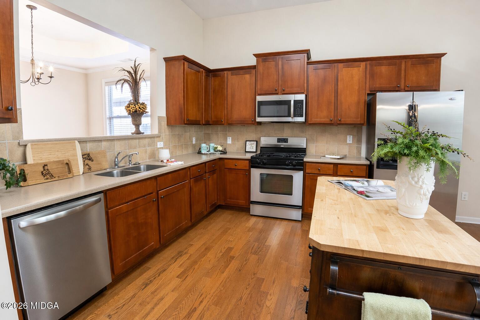 339 Fairways Drive Macon, GA 31220 - Photo 12 of 37 a kitchen with stainless steel appliances a sink a stove a refrigerator cabinets and a window