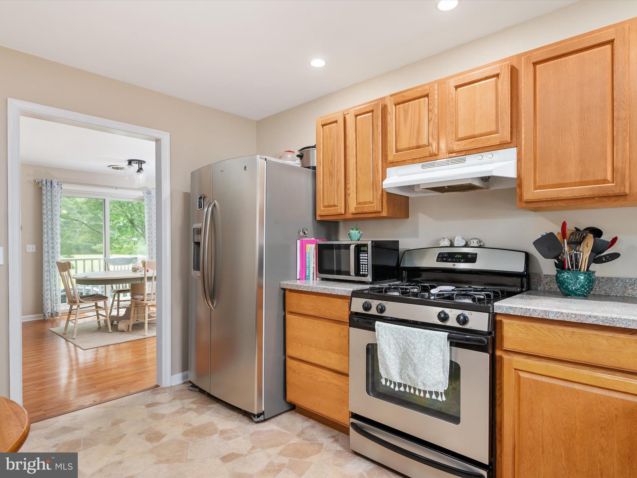 113 Radcliffe Road Grasonville, MD 21638 - Photo 11 of 30 a kitchen with stainless steel appliances granite countertop a refrigerator stove and sink