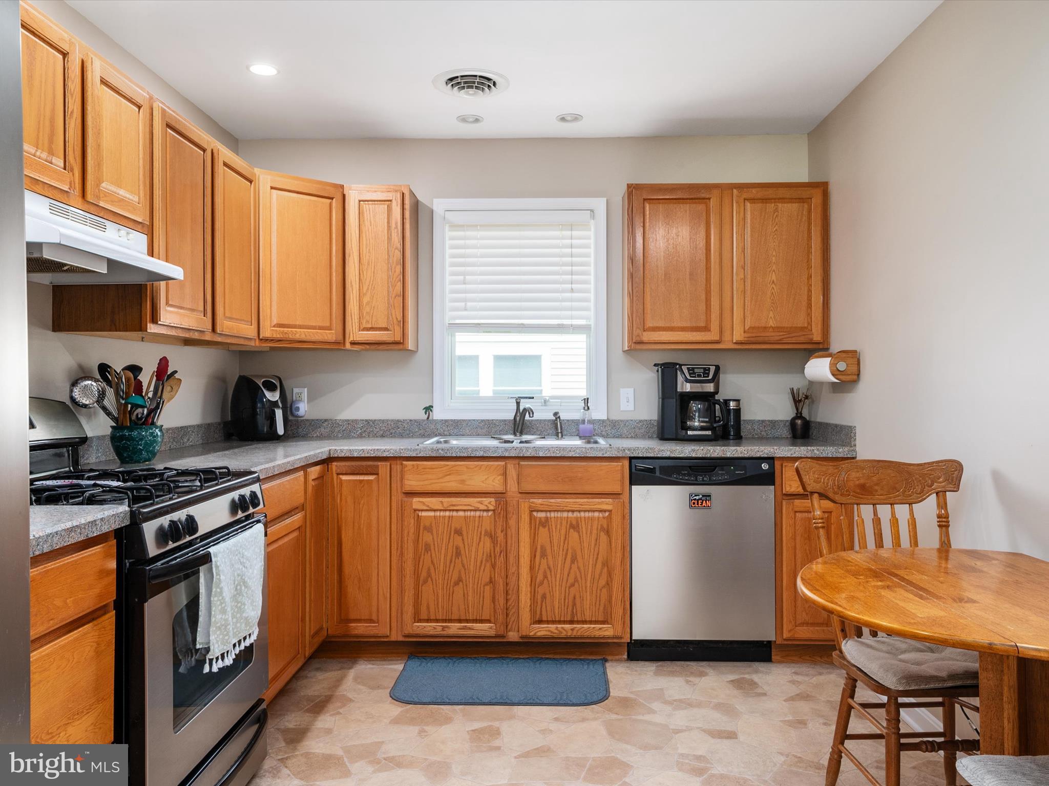 113 Radcliffe Road Grasonville, MD 21638 - Photo 10 of 30 a kitchen with stainless steel appliances granite countertop a stove a sink dishwasher and a refrigerator