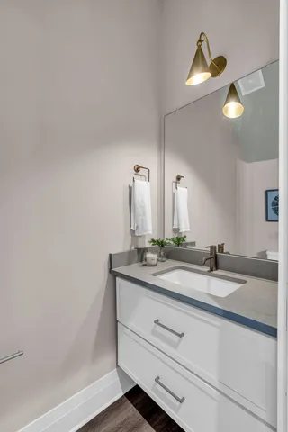 a bathroom with a granite countertop sink and a mirror