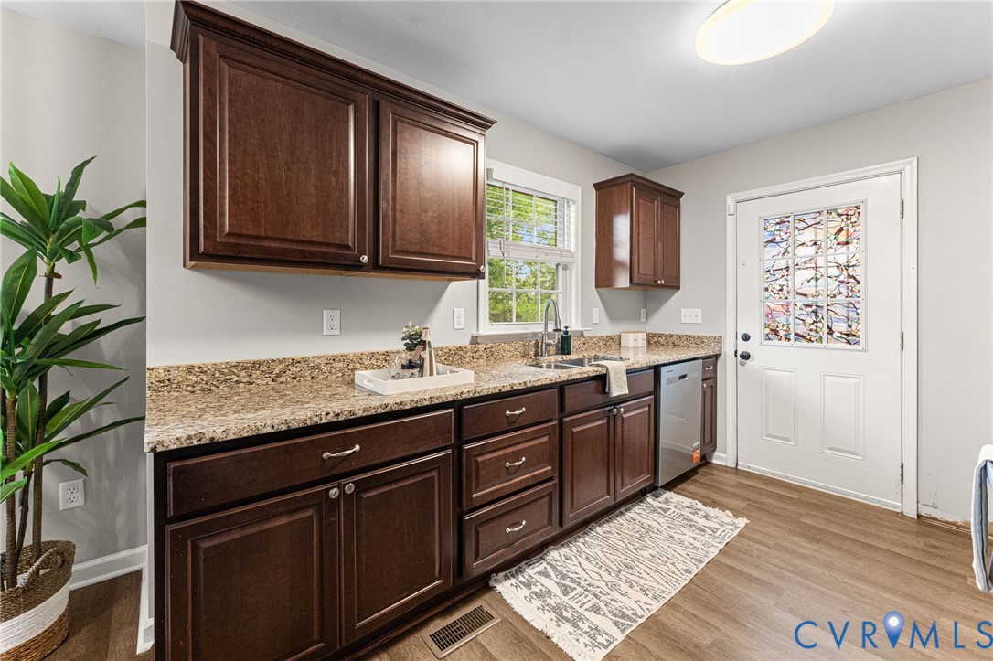 829 Rome Street Petersburg, VA 23803 - Photo 8 of 22 a kitchen with granite countertop stainless steel appliances a sink stove and cabinets