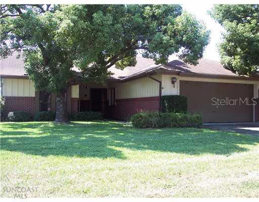 13713 Whitby Road Hudson, FL 34667 - Photo 1 of 1 a view of a house with a yard potted plants and a large tree