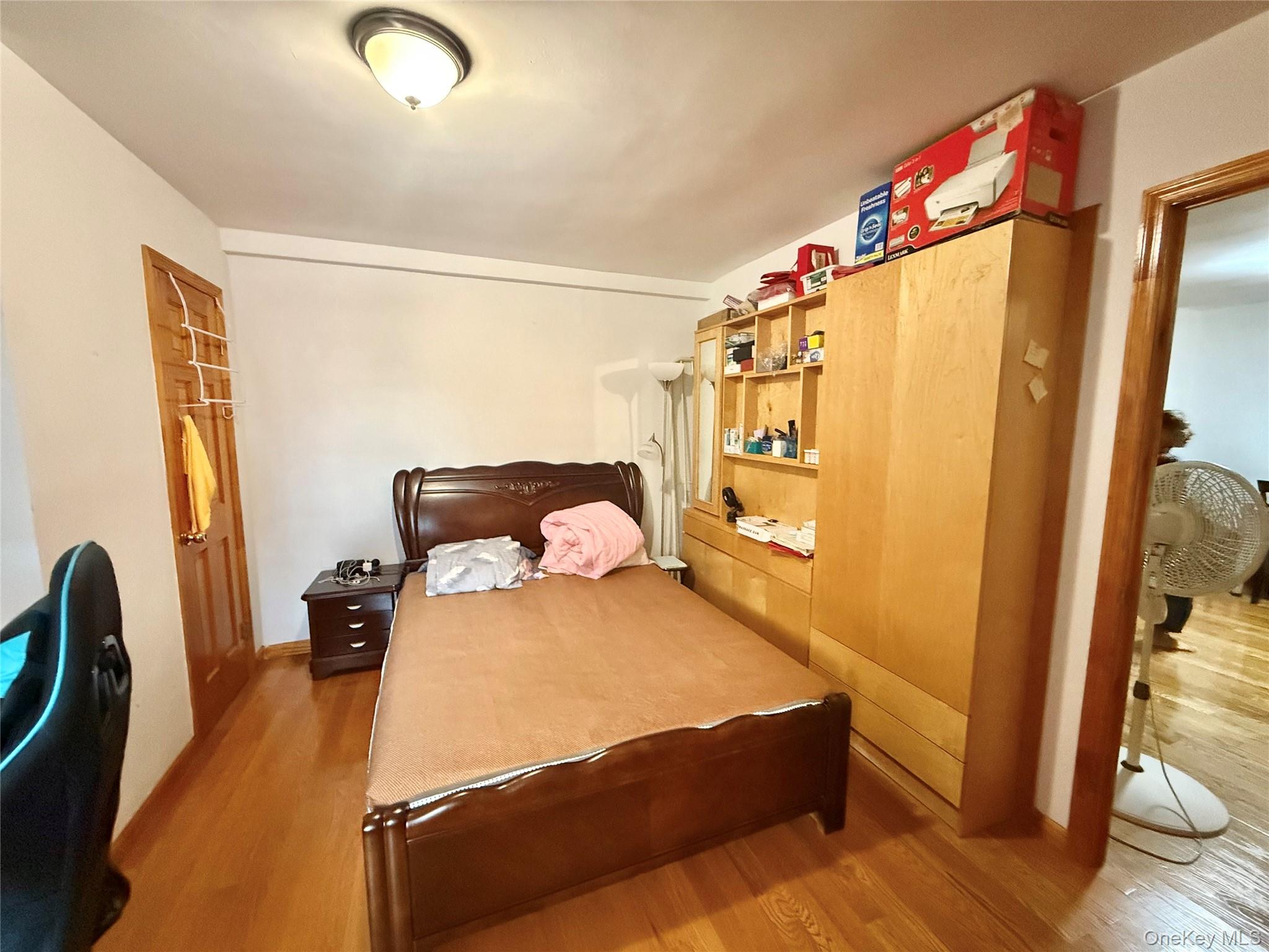 138-70 Elder Avenue, Unit 3A Queens, NY 11355 - Photo 8 of 10 a bedroom with a bed and wooden floor