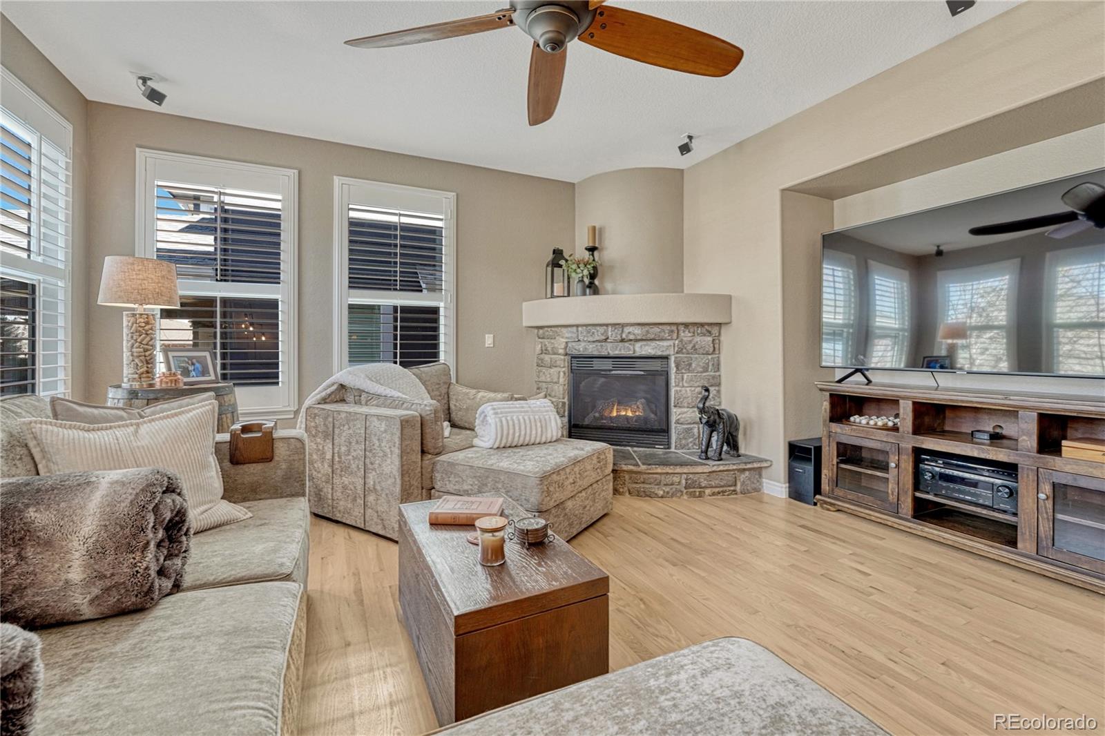 10761 Glengate Circle Highlands Ranch, CO 80130 - Photo 13 of 39 a living room with furniture and a fireplace