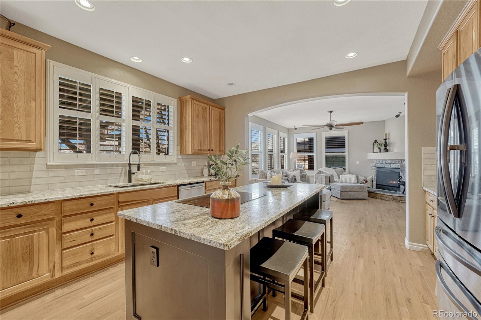 10761 Glengate Circle Highlands Ranch, CO 80130 - Photo 15 of 39 a kitchen with sink refrigerator and cabinets