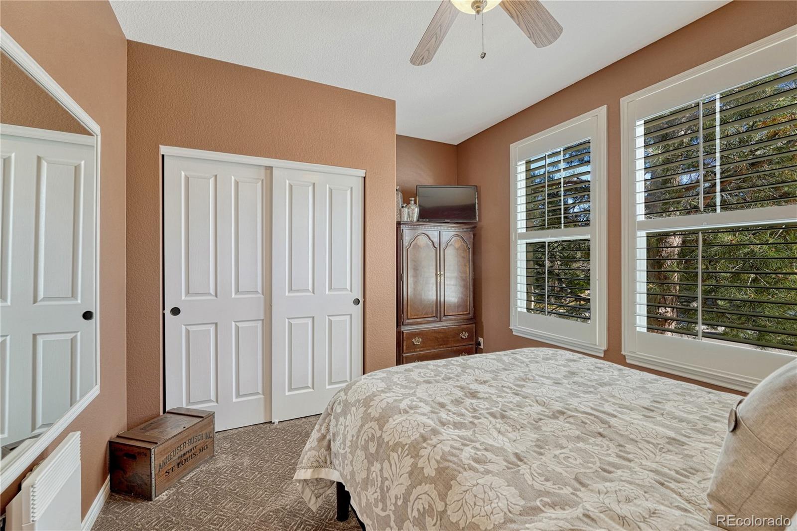 10761 Glengate Circle Highlands Ranch, CO 80130 - Photo 19 of 39 a bedroom with a bed and a large window