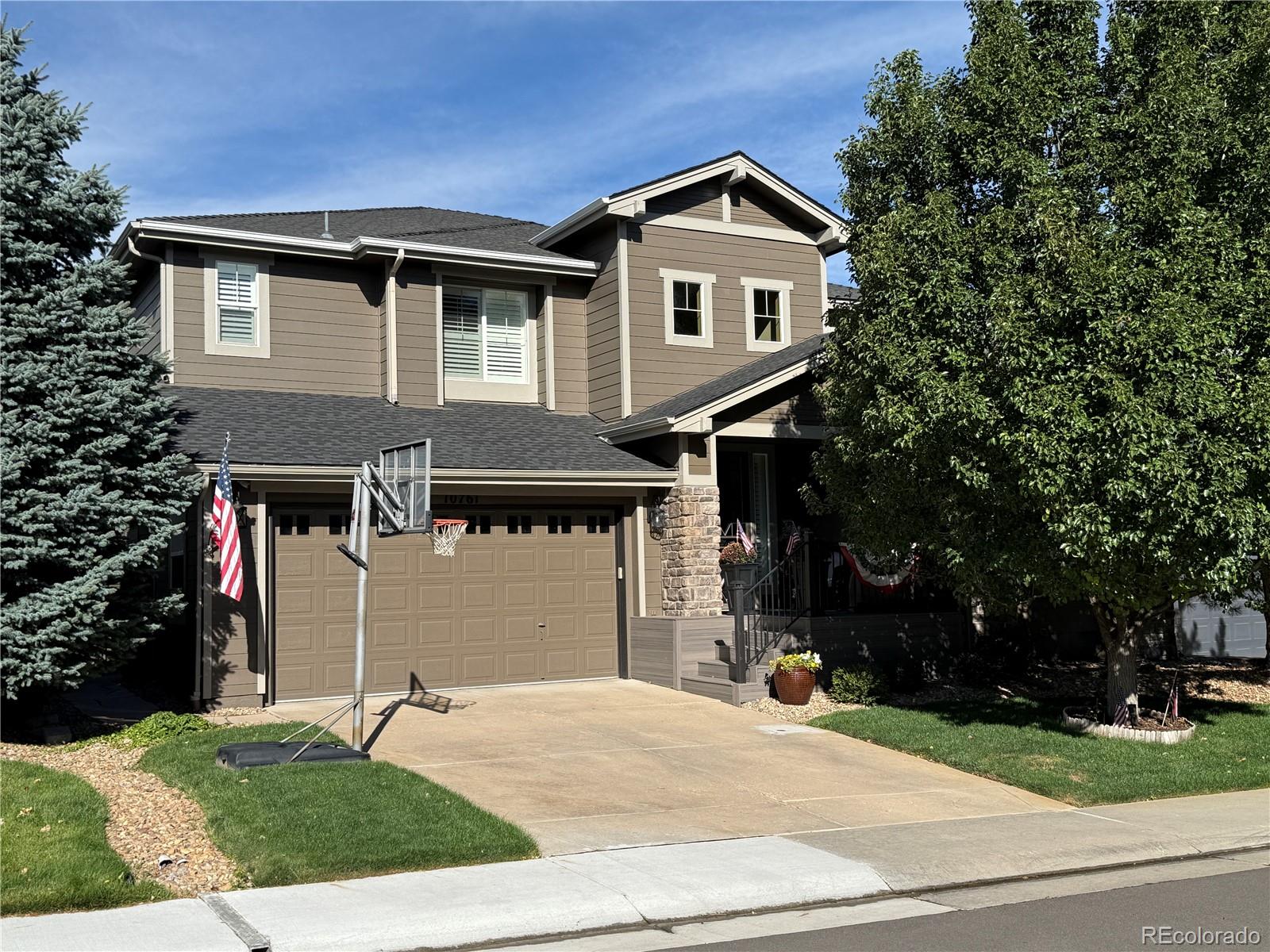 10761 Glengate Circle Highlands Ranch, CO 80130 - Photo 2 of 39 a front view of a house with a yard and garage