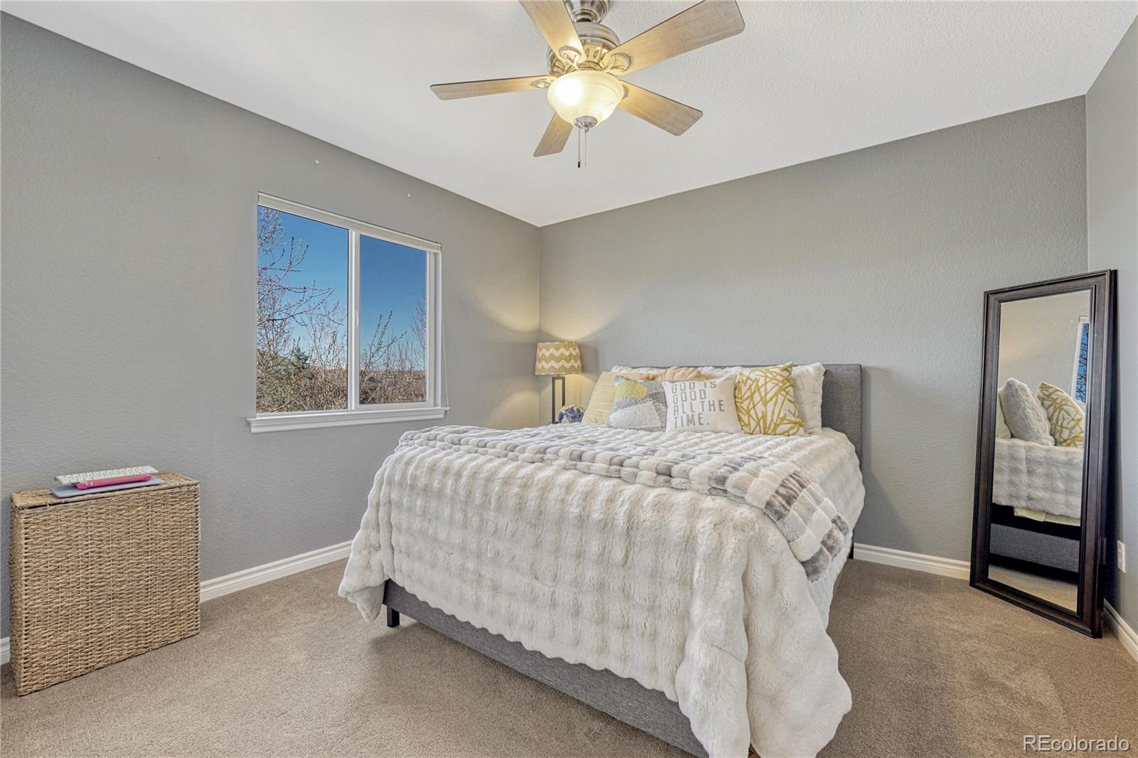 10761 Glengate Circle Highlands Ranch, CO 80130 - Photo 27 of 39 a bedroom with a bed and a chandelier