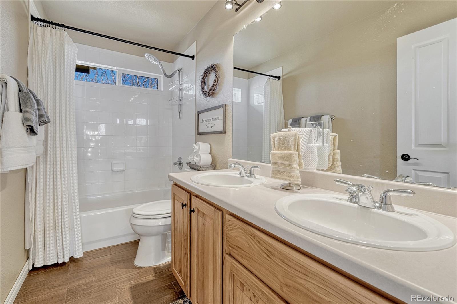 10761 Glengate Circle Highlands Ranch, CO 80130 - Photo 28 of 39 a bathroom with a sink toilet a shower and a mirror