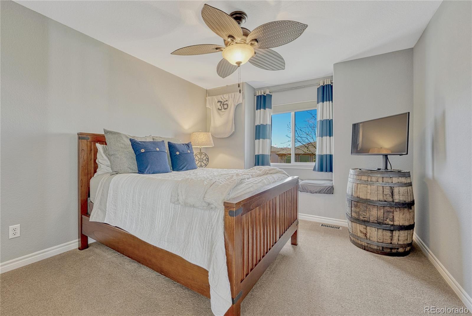 10761 Glengate Circle Highlands Ranch, CO 80130 - Photo 29 of 39 a spacious bedroom with a bed and a flat screen tv