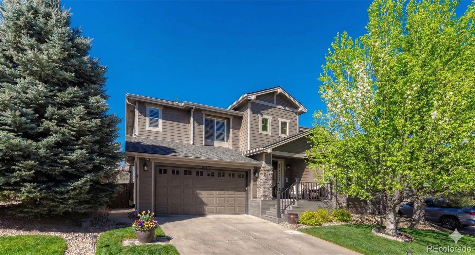 10761 Glengate Circle Highlands Ranch, CO 80130 - Photo 3 of 39 a front view of a house with garden