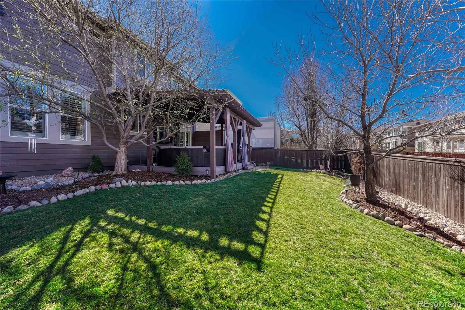 10761 Glengate Circle Highlands Ranch, CO 80130 - Photo 33 of 39 a view of a house with a yard