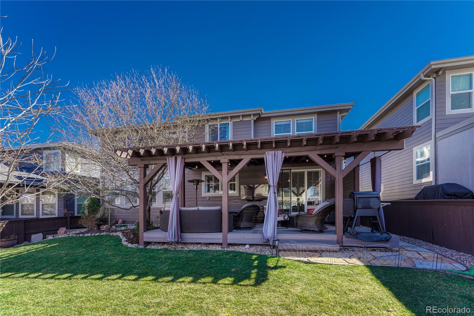 10761 Glengate Circle Highlands Ranch, CO 80130 - Photo 34 of 39 a view of a house with a yard porch and sitting area