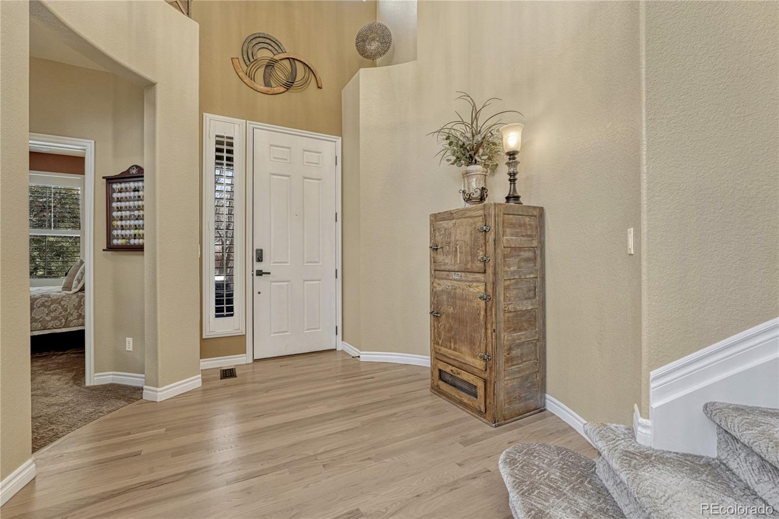 10761 Glengate Circle Highlands Ranch, CO 80130 - Photo 8 of 39 a view of entryway with wooden floor