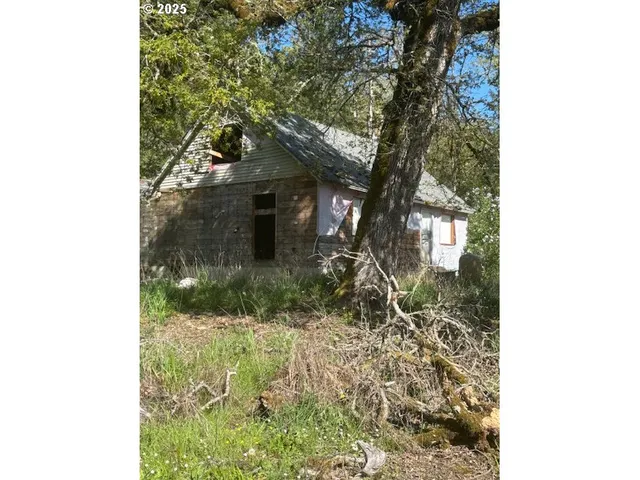 a yellow house with trees in front of it