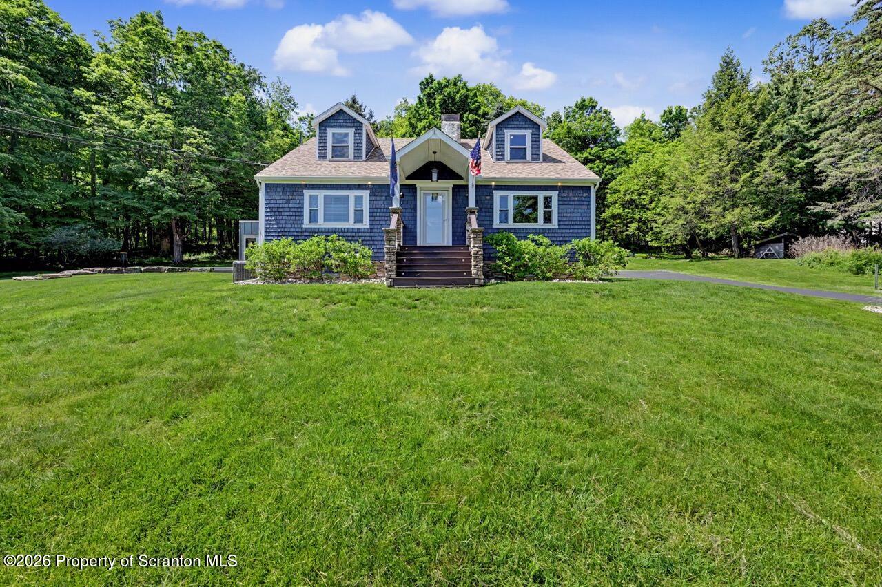 457 Craig Road Dalton, PA 18414 - Photo 4 of 114 a front view of a house with a garden