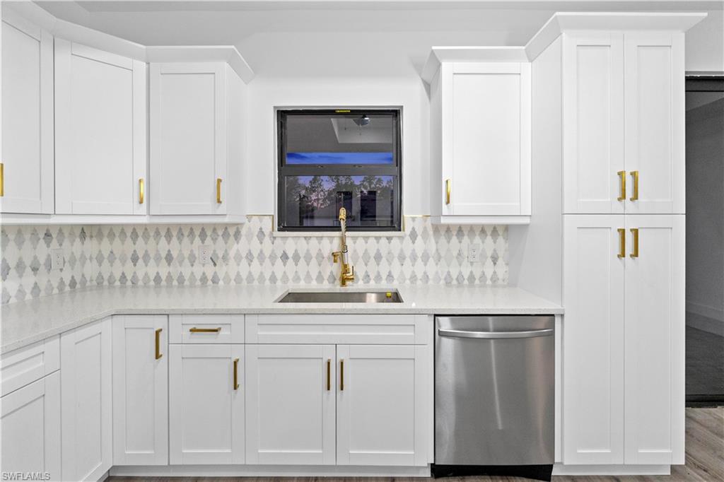 2714 24th Street West Lehigh Acres, FL 33971 - Photo 16 of 48 a kitchen with white cabinets and sink