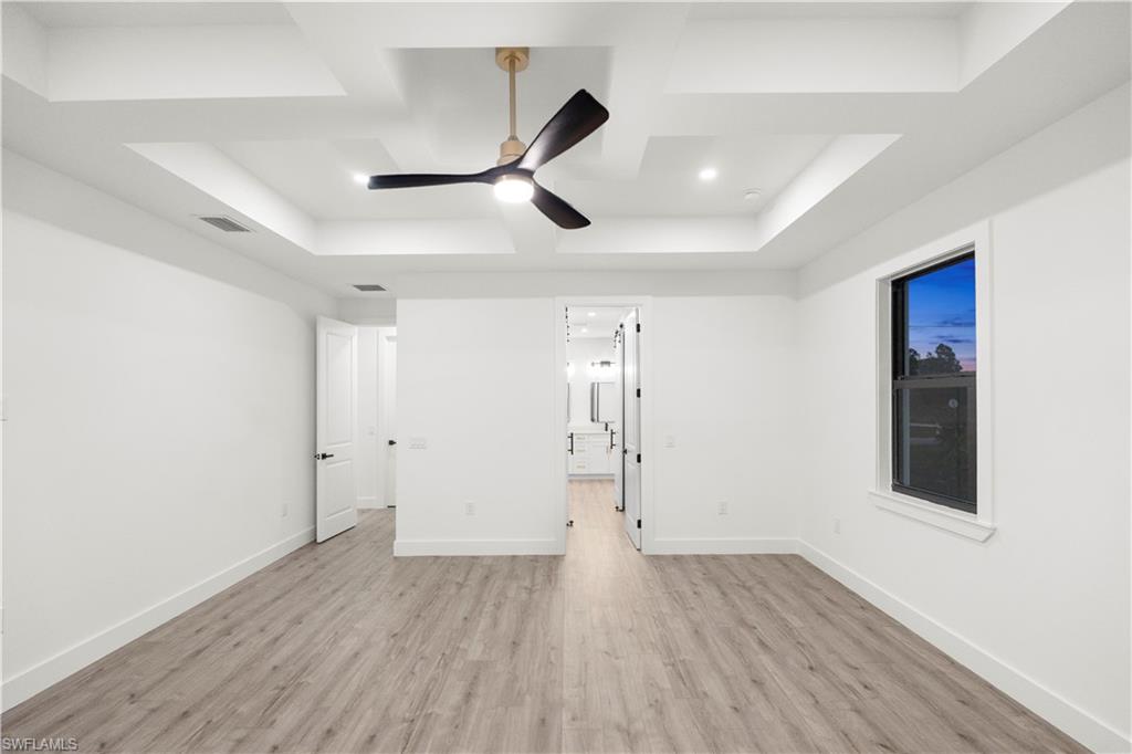 2714 24th Street West Lehigh Acres, FL 33971 - Photo 26 of 48 an empty room with wooden floor and windows