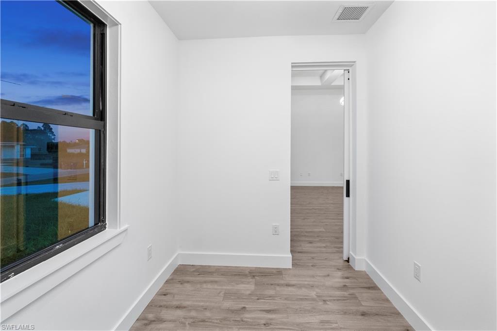 2714 24th Street West Lehigh Acres, FL 33971 - Photo 34 of 48 a view of an empty room with wooden floor