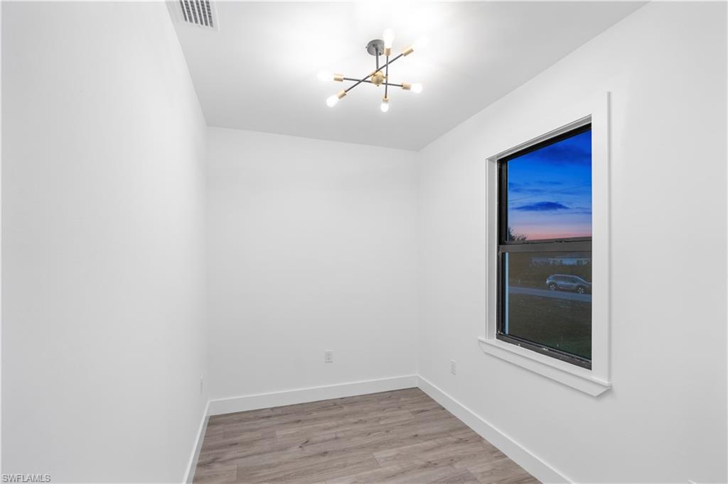 2714 24th Street West Lehigh Acres, FL 33971 - Photo 35 of 48 an empty room with a window and a ceiling fan