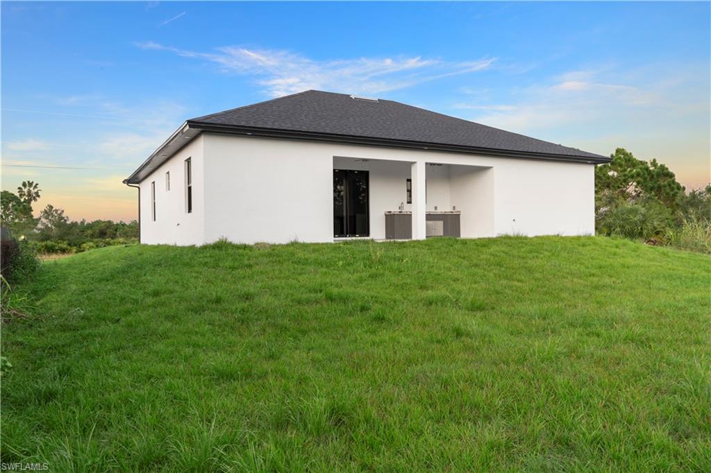 2714 24th Street West Lehigh Acres, FL 33971 - Photo 46 of 48 a view of a house with a yard