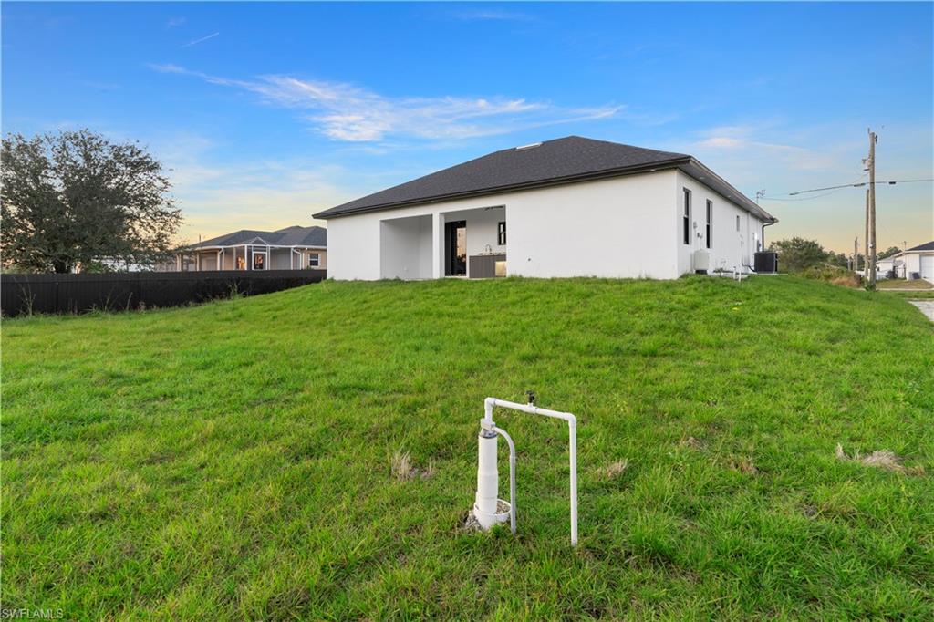 2714 24th Street West Lehigh Acres, FL 33971 - Photo 47 of 48 a house view with a garden space