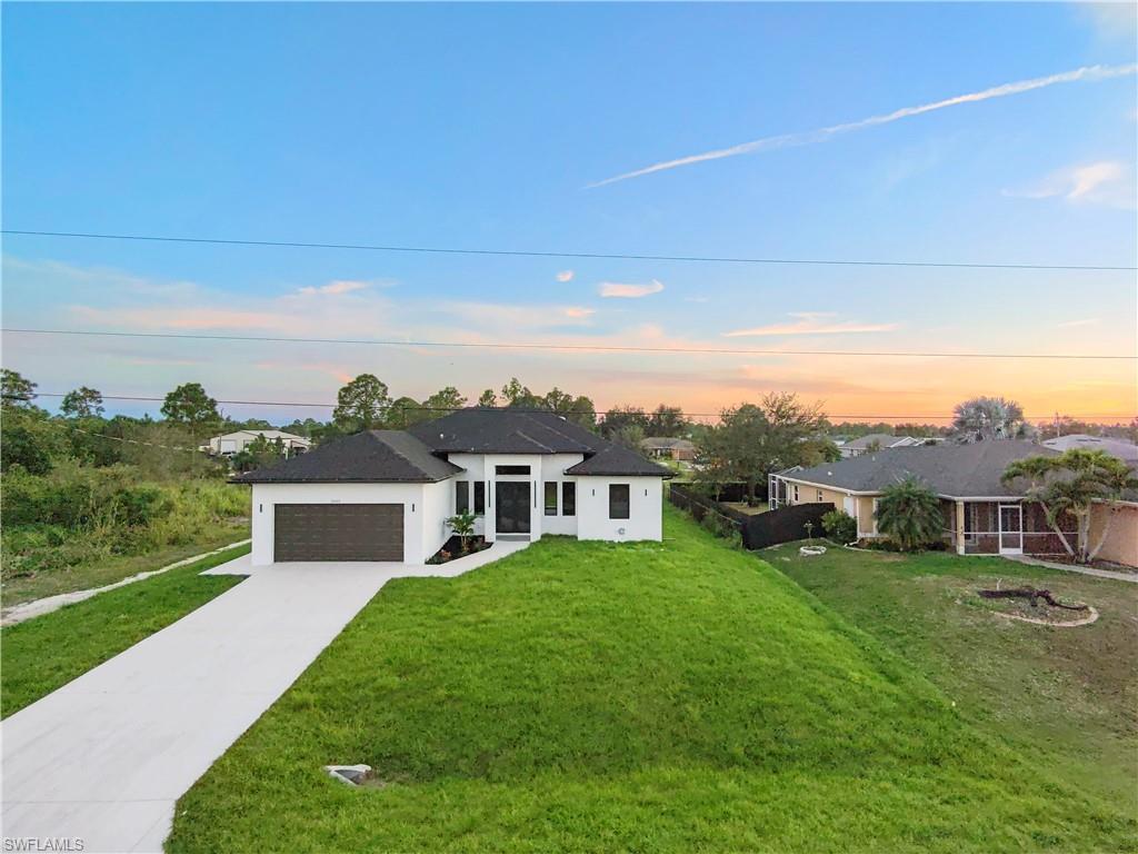 2714 24th Street West Lehigh Acres, FL 33971 - Photo 6 of 48 a house view with a garden space