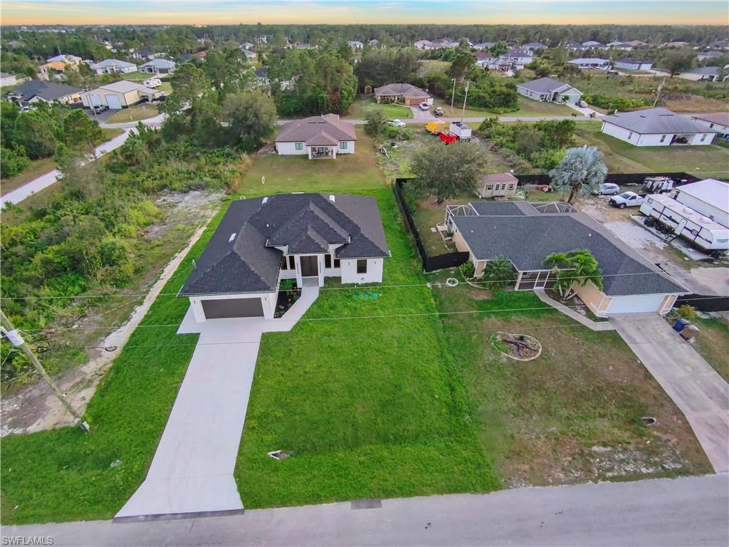 2714 24th Street West Lehigh Acres, FL 33971 - Photo 7 of 48 an aerial view of a house with a garden