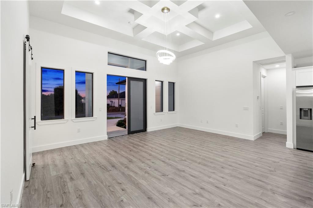 2714 24th Street West Lehigh Acres, FL 33971 - Photo 9 of 48 a view of an empty room with window and wooden floor