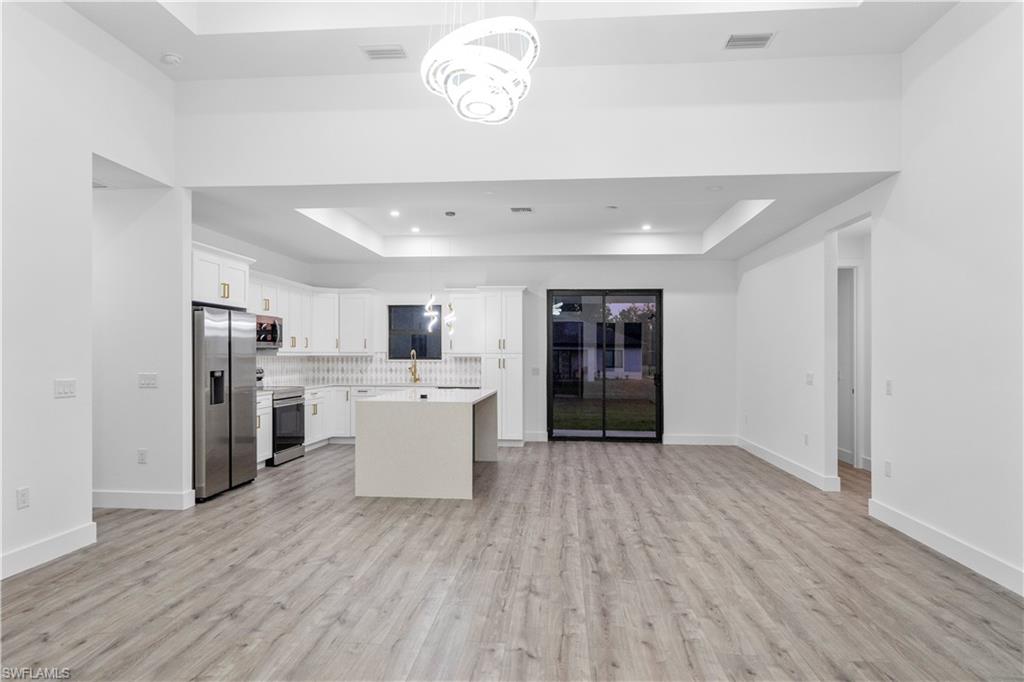 2714 24th Street West Lehigh Acres, FL 33971 - Photo 10 of 48 a view of kitchen with cabinets stainless steel appliances and wooden floor