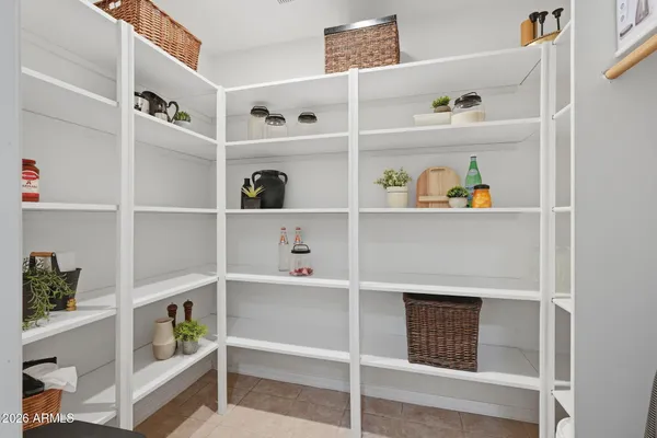 a bedroom with a bed and a flat tv screen on dresser
