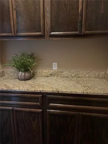 a sink with granite countertop cabinets