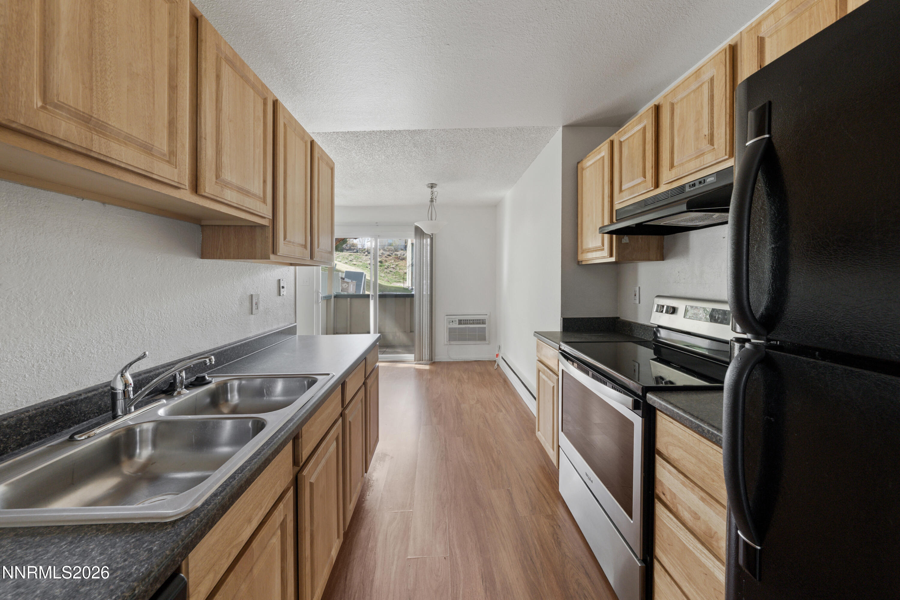 3942 Clear Acre Lane, Unit 241 Reno, NV 89512 - Photo 17 of 23 a kitchen with a sink stove top oven and cabinets
