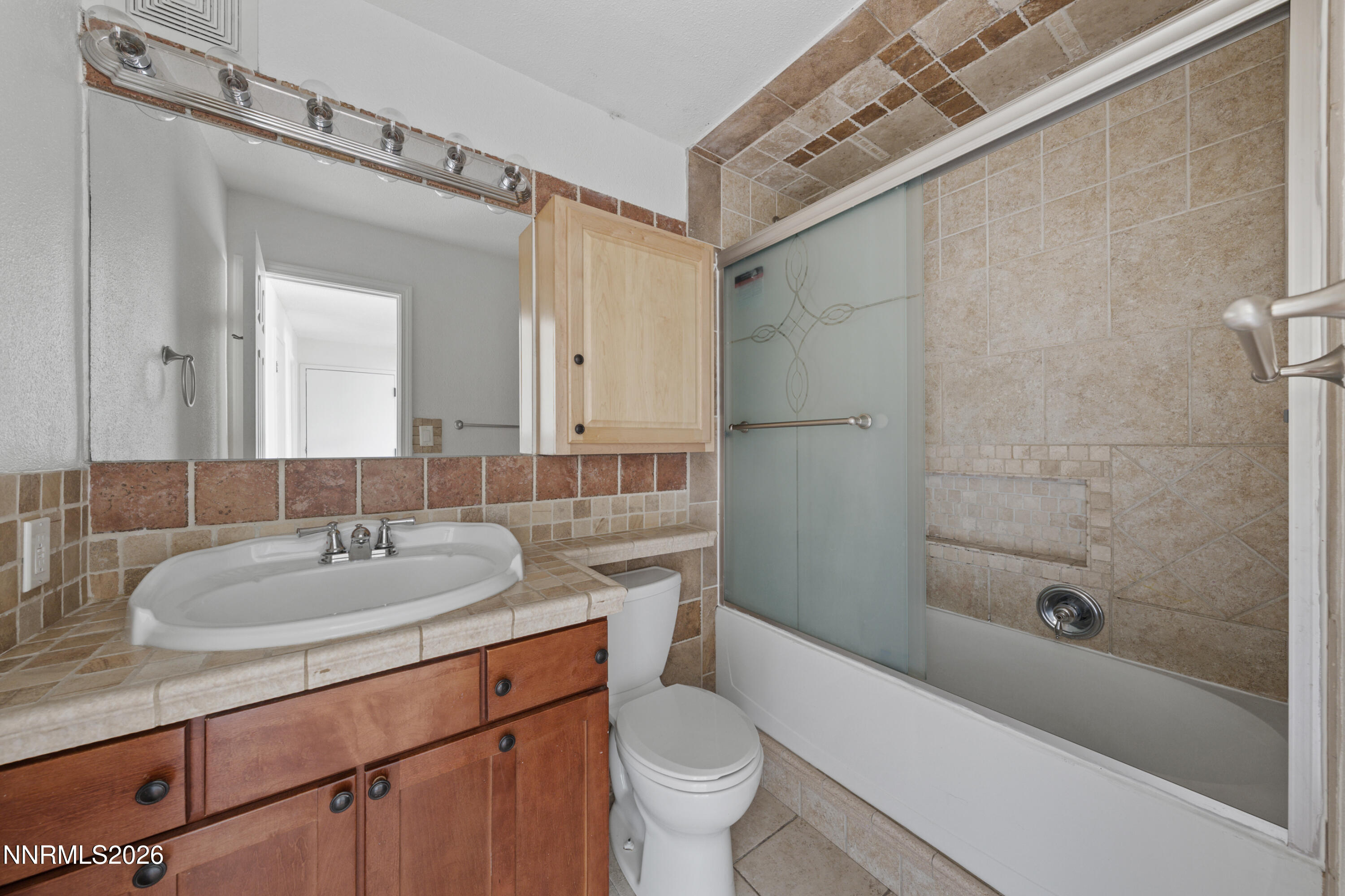 3942 Clear Acre Lane, Unit 241 Reno, NV 89512 - Photo 9 of 23 a bathroom with a sink and a mirror