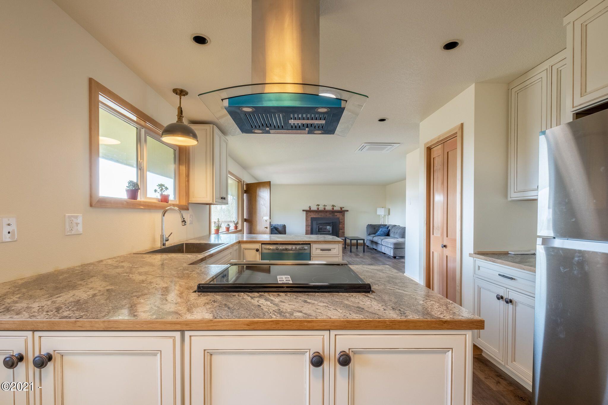 3048 Northeast East Line Road Yachats, OR 97498 - Photo 10 of 31 a kitchen with stainless steel appliances granite countertop a sink a stove and refrigerator