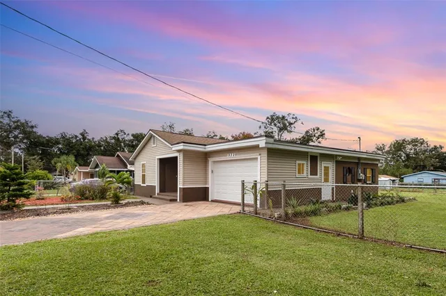 a front view of a house with a yard and trees