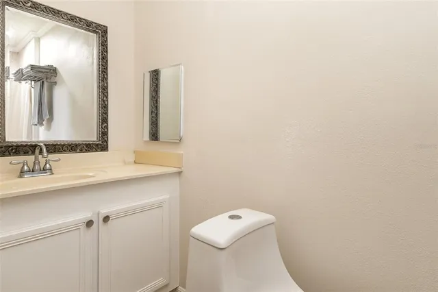 a bathroom with a sink a toilet and mirror