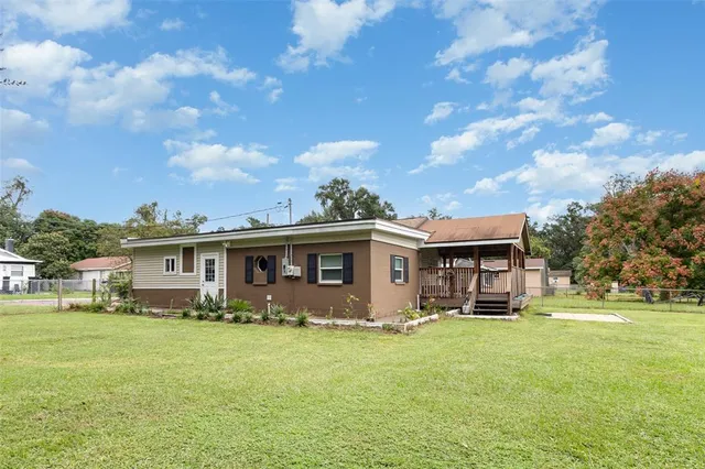 a front view of house with yard and green space