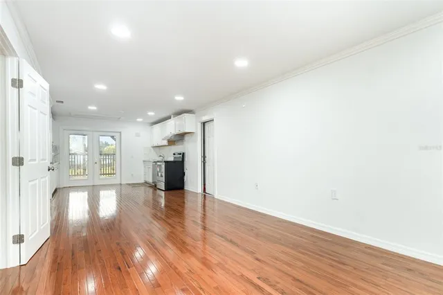 a view of a kitchen with wooden floor and a window